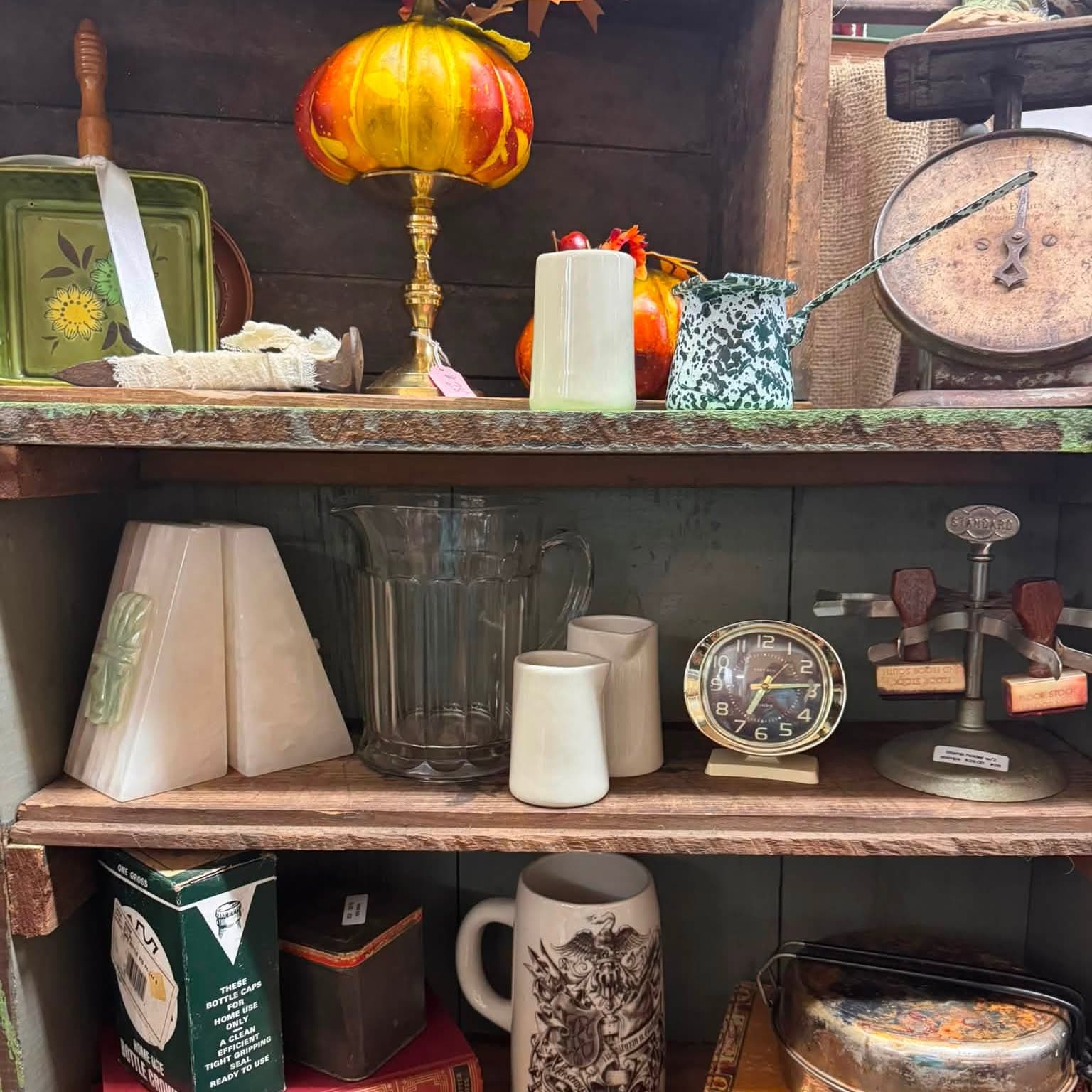 Shelves of glassware, a lamp, an antique scale and assorted small collectibles