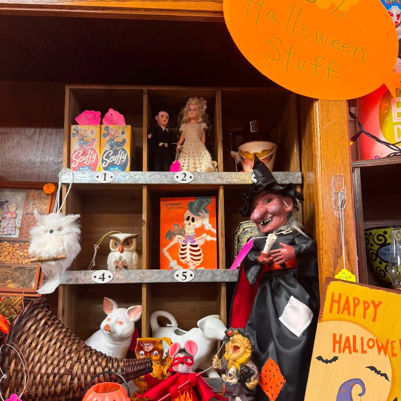 Halloween display of a witch figure, skeleton and Happy Halloween sign